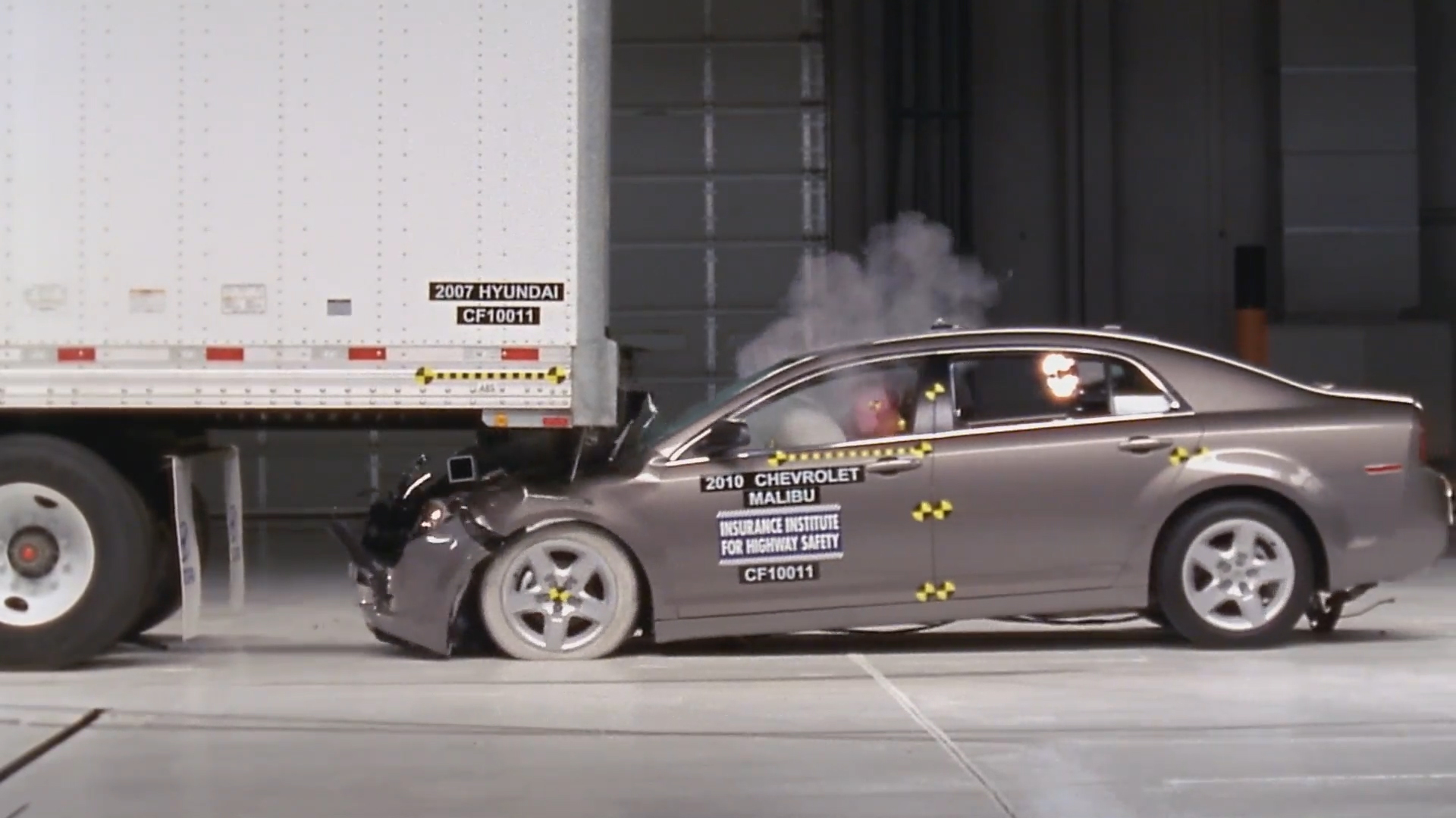 A car slides under a truck in an 'underride crash' in a failed test of a rear underride guard.